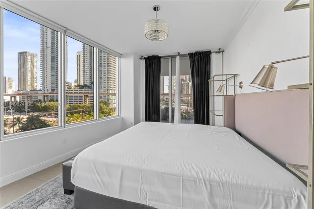 a bedroom with a large bed and a large window