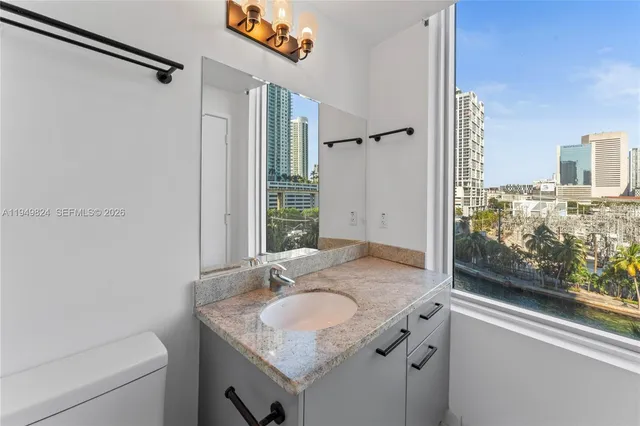 a bathroom with a sink mirror and toilet
