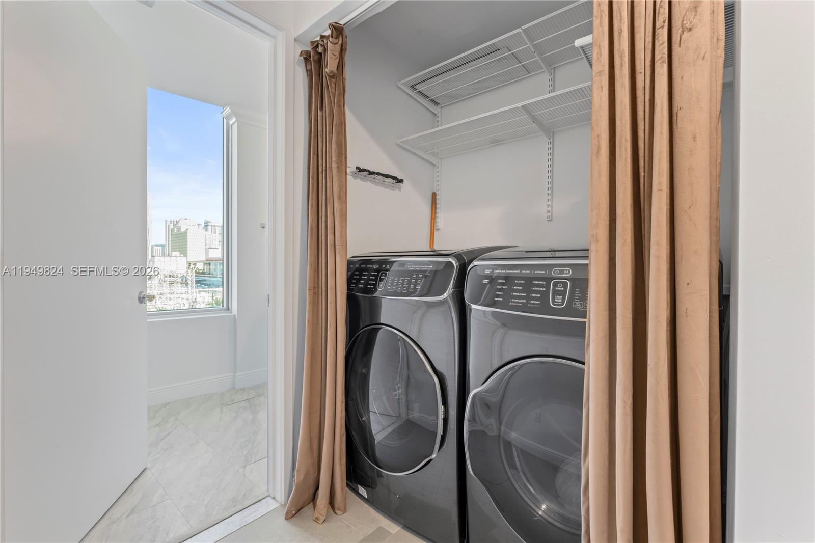 185 Southwest 7th Street, Unit 603 Miami, FL 33130 - Photo 28 of 32 a utility room with dryer and washer