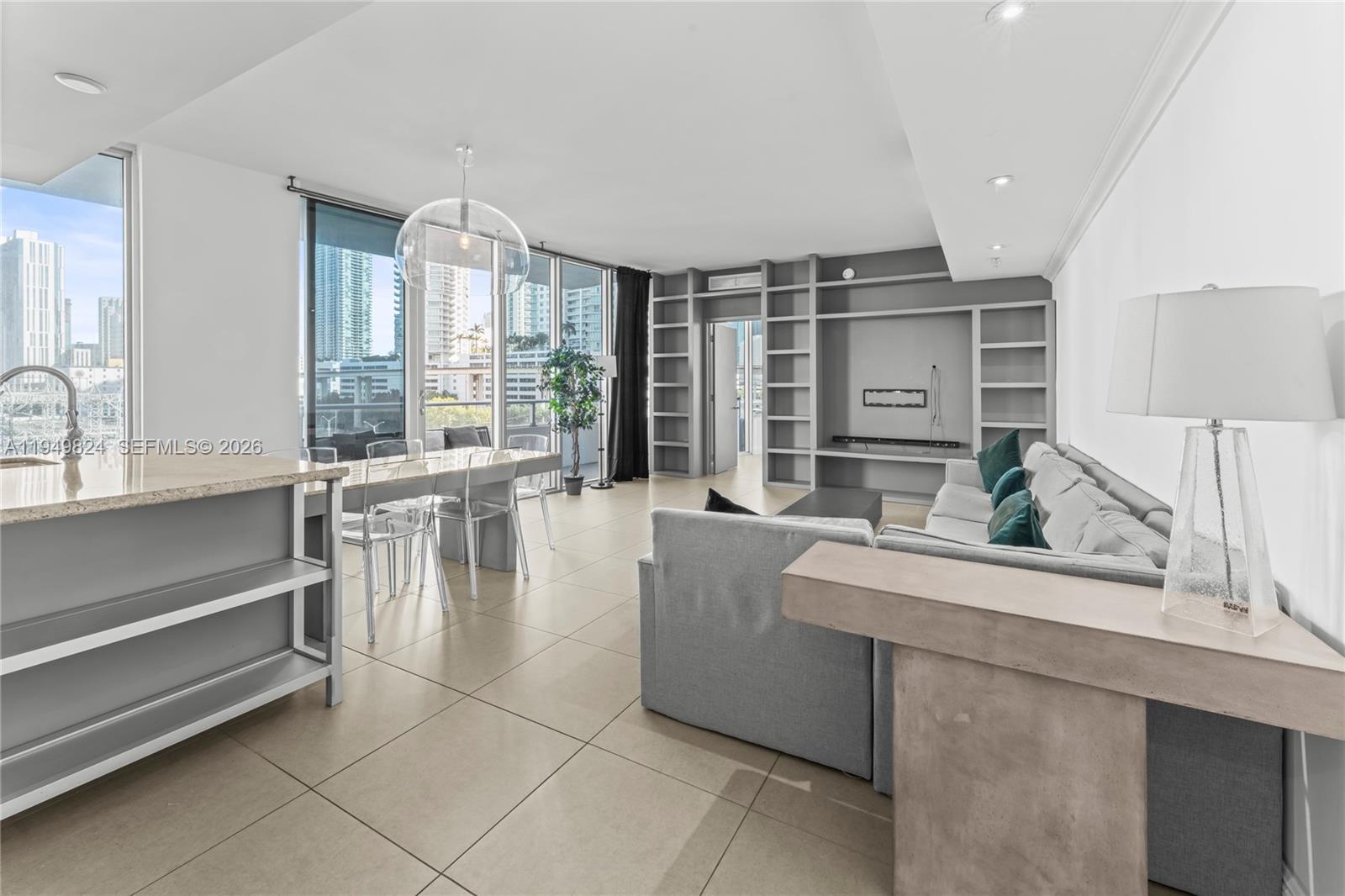 185 Southwest 7th Street, Unit 603 Miami, FL 33130 - Photo 3 of 32 a living room with furniture and large windows