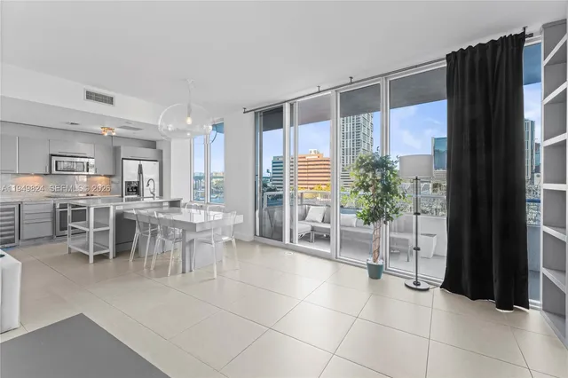 a dining hall with a large window and outdoor space