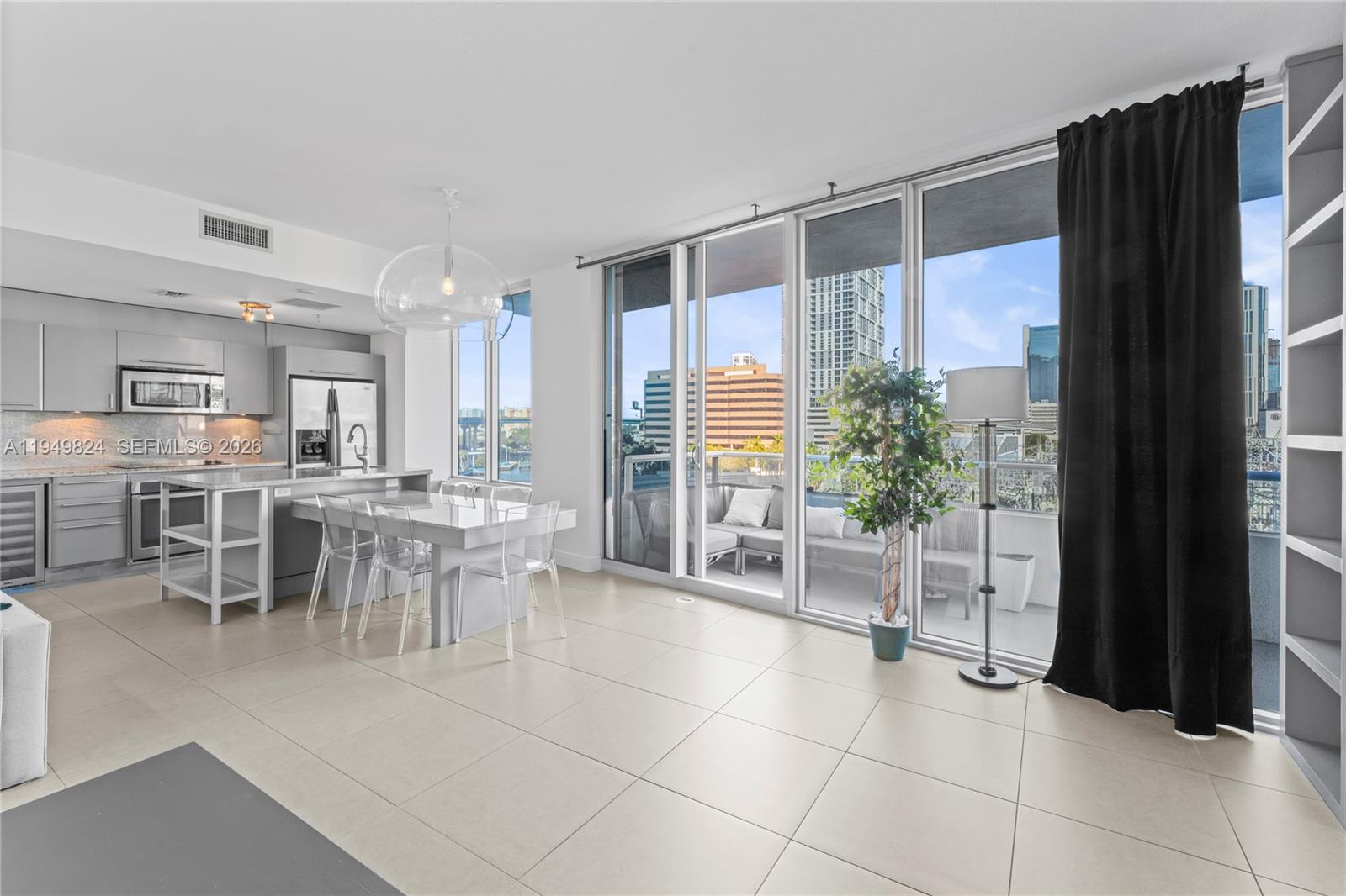 185 Southwest 7th Street, Unit 603 Miami, FL 33130 - Photo 5 of 32 a dining hall with a large window and outdoor space