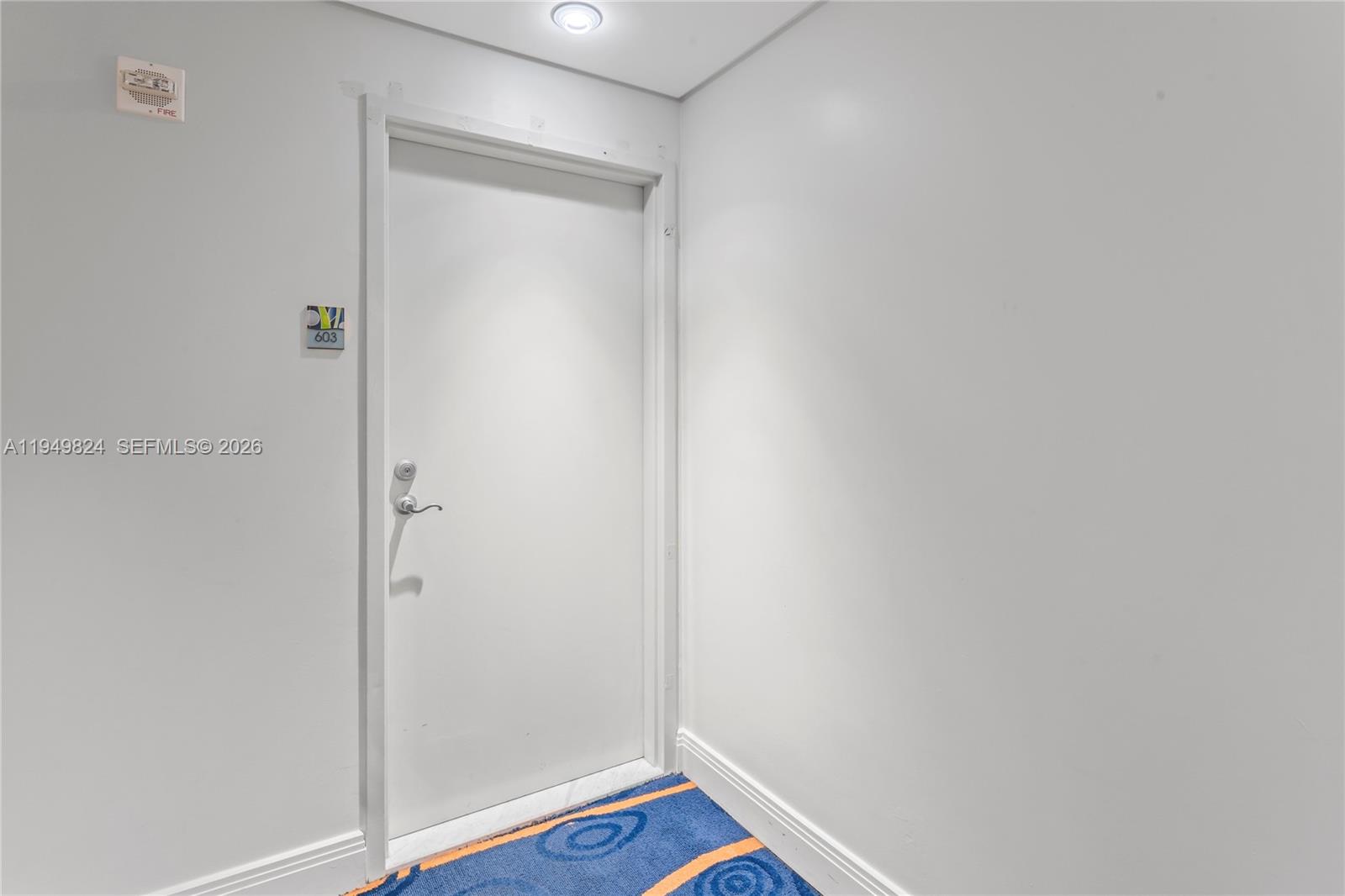 185 Southwest 7th Street, Unit 603 Miami, FL 33130 - Photo 6 of 32 a room with a wooden floor and closet