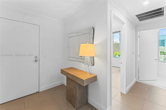 a bathroom with a toilet a light fixture and a window