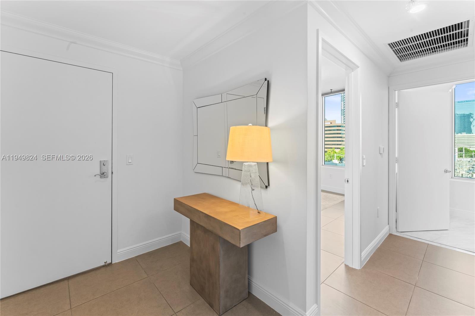 185 Southwest 7th Street, Unit 603 Miami, FL 33130 - Photo 8 of 32 a bathroom with a toilet a light fixture and a window