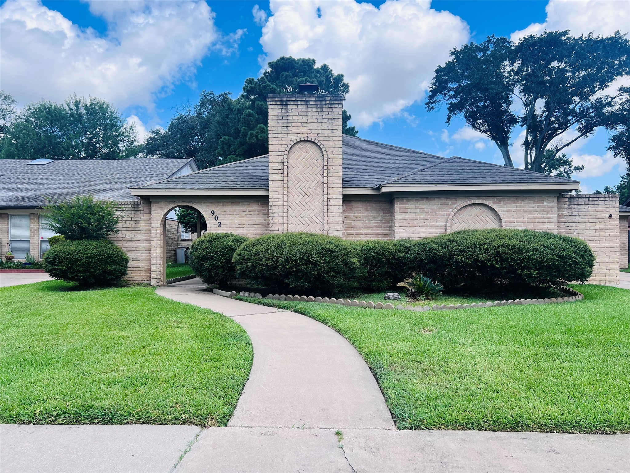 902 Hidden Canyon Road Katy, TX 77450 - Photo 1 of 20 This charming home features a classic brick exterior with a welcoming arched entryway. It boasts a well-maintained lawn, mature landscaping, and a curved walkway leading to the front door. Ideal for those seeking a cozy and inviting curb appeal.