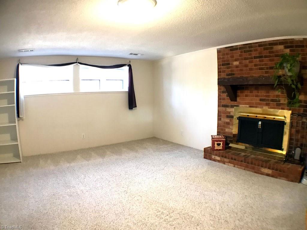 1713 Valley Brook Road Clemmons, NC 27012 - Photo 14 of 23 Lower level Den with fireplace