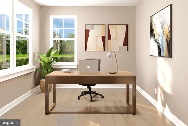 a view of a workspace with furniture and window