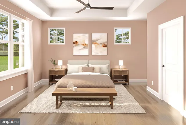 a spacious bedroom with a bed and wooden floor