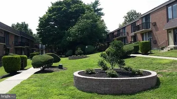 a house view with a garden space and seating space