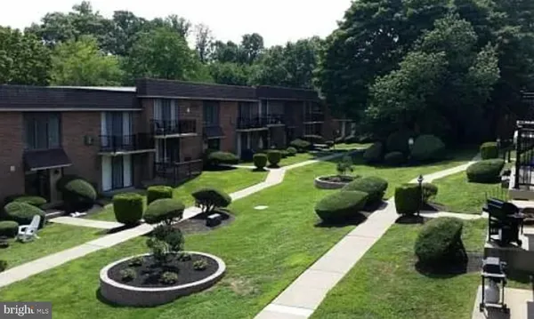 a backyard of a house with yard fountain and outdoor seating