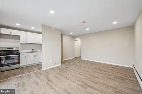 a view of kitchen with wooden floor electronic appliances and window
