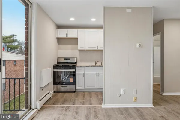 a kitchen with a refrigerator and a stove
