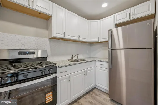 a white refrigerator freezer sitting inside of a kitchen