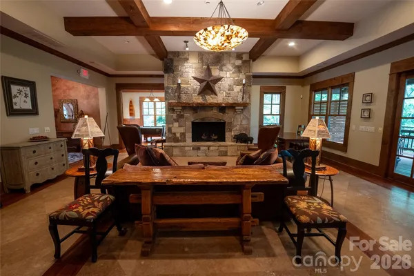 a view of a dining room with furniture a chandelier and wooden floor