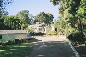 205 Hot Springs Road Santa Barbara, CA 93108 - Photo 5 of 6 a front view of a house with a yard and trees