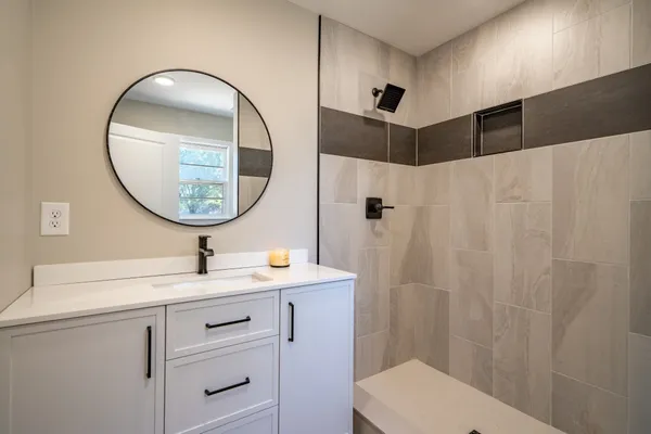 a bathroom with a sink a toilet and a mirror