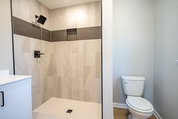 a bathroom with a toilet and a shower