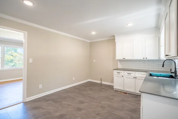 a kitchen with granite countertop a sink and a stove top oven