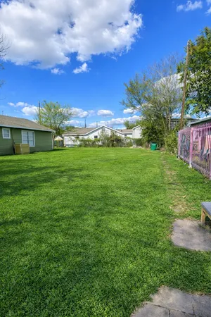 a view of a big yard with a house in the background