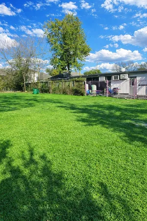 a view of yard with swimming pool and green space
