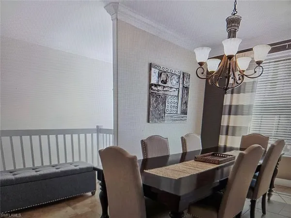 a view of a dining room with furniture and a potted plant
