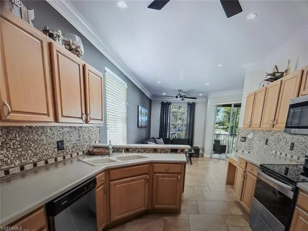 a kitchen with stainless steel appliances granite countertop a sink stove and cabinets
