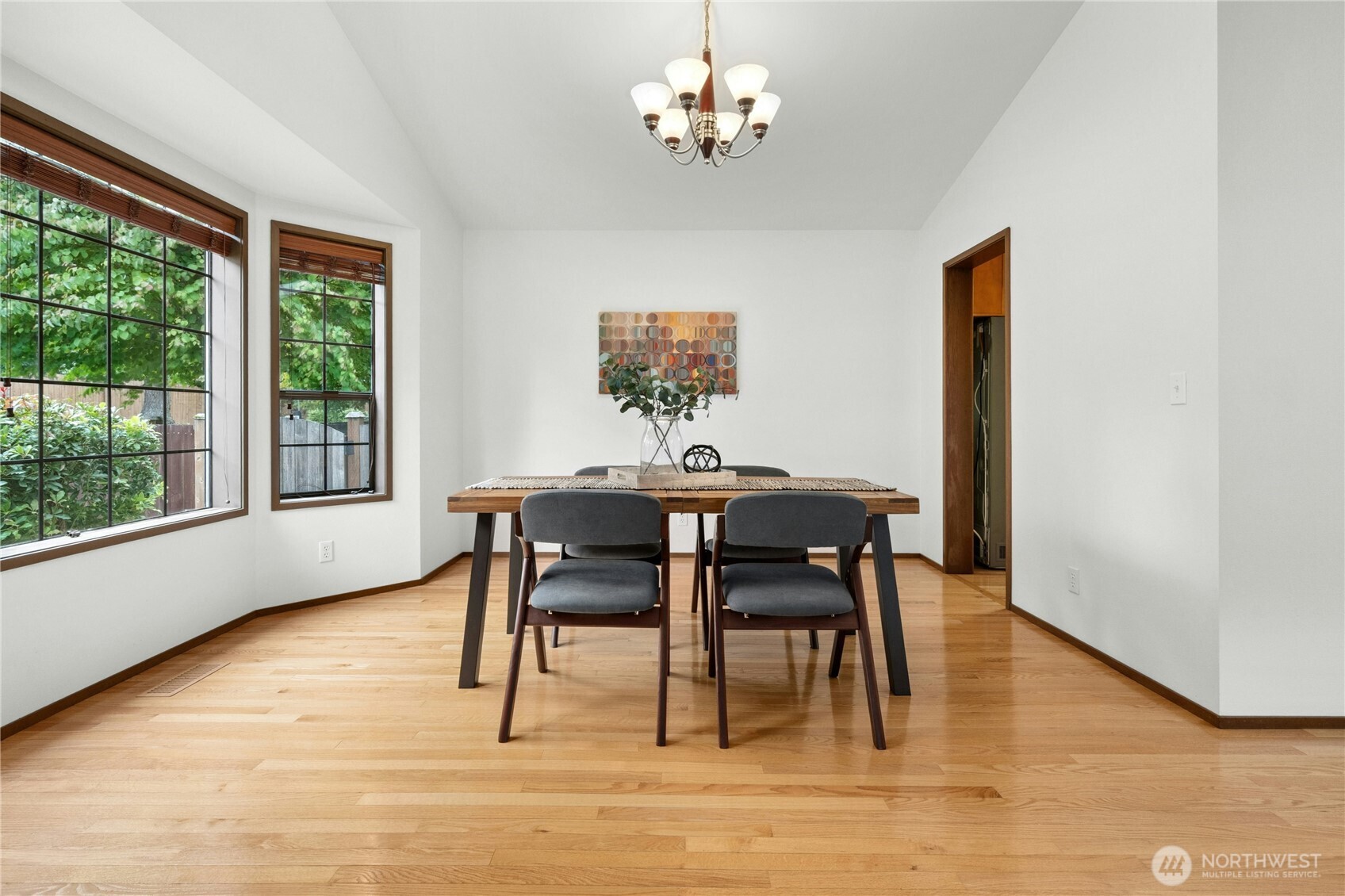 5211 103rd Street Southwest, Unit SW Mukilteo, WA 98275 - Photo 9 of 40 a dining room with furniture a window and a chandelier