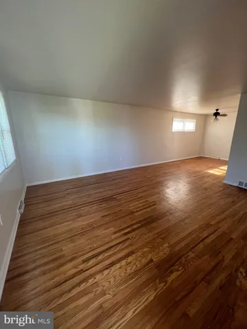 a view of an empty room and wooden floor