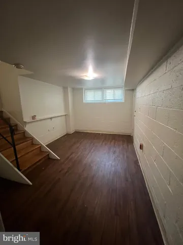 a view of a room with wooden floors and stairs
