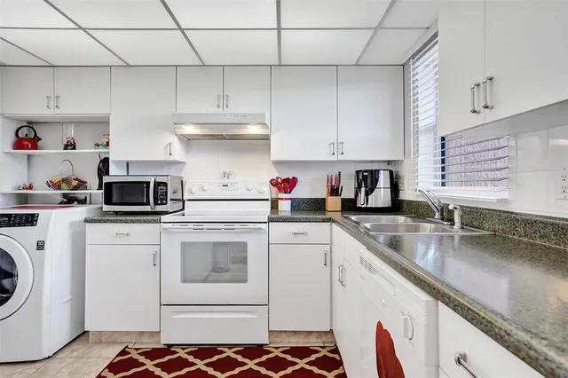 a kitchen with sink and cabinets