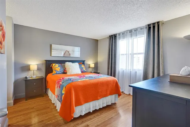 a bedroom with a bed and a dresser in it