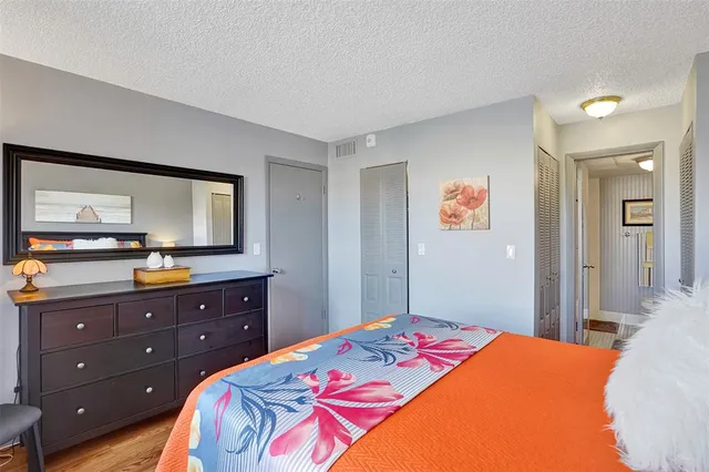 a bedroom with furniture and wooden floor