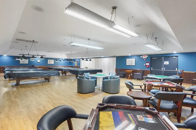 a view of a patio with table and chairs potted plants and palm tree
