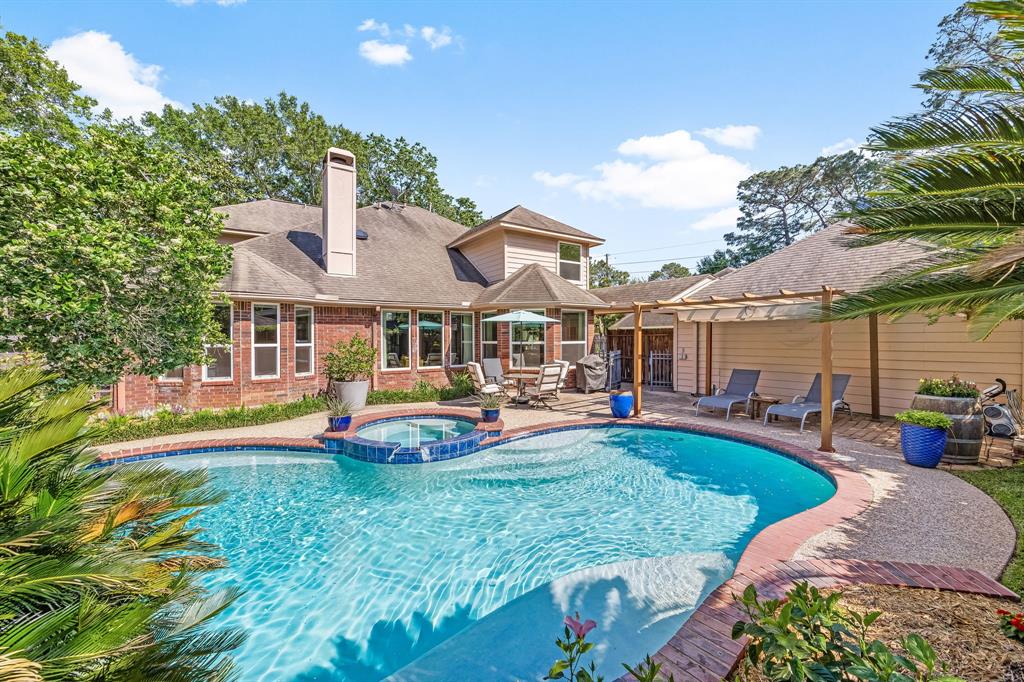 7607 Rolling Rock Street Houston, TX 77040 - Photo 1 of 49 a front view of a house with swimming pool garden and patio