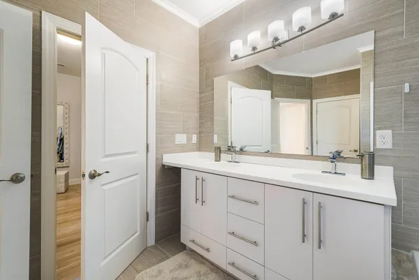 a bathroom with a sink toilet and a mirror
