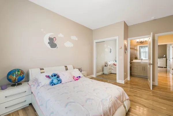 a room with a bed and a potted plant