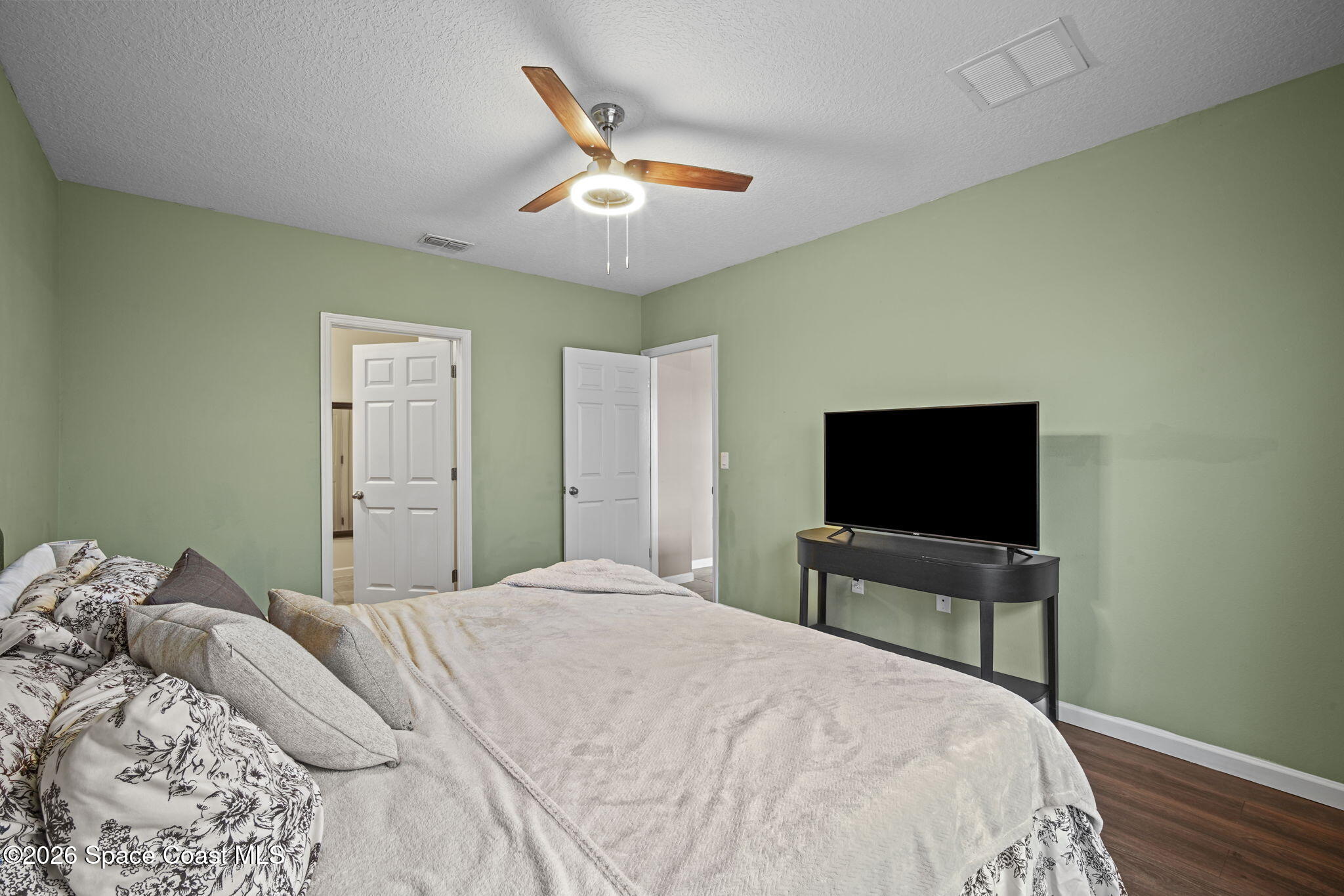 3818 Loggerhead Lane Mims, FL 32754 - Photo 16 of 30 a bedroom with a bed and a flat screen tv
