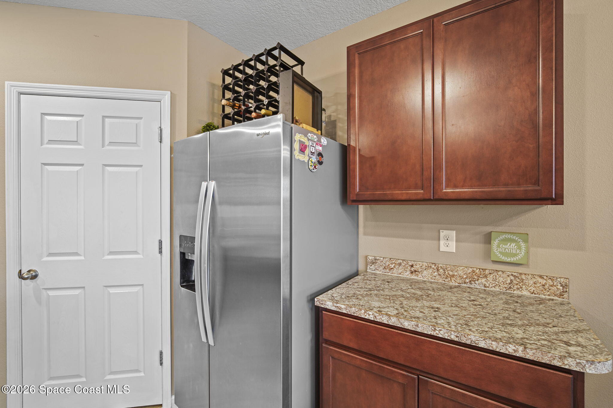 3818 Loggerhead Lane Mims, FL 32754 - Photo 8 of 30 a kitchen with stainless steel appliances granite countertop a refrigerator and a stove top oven