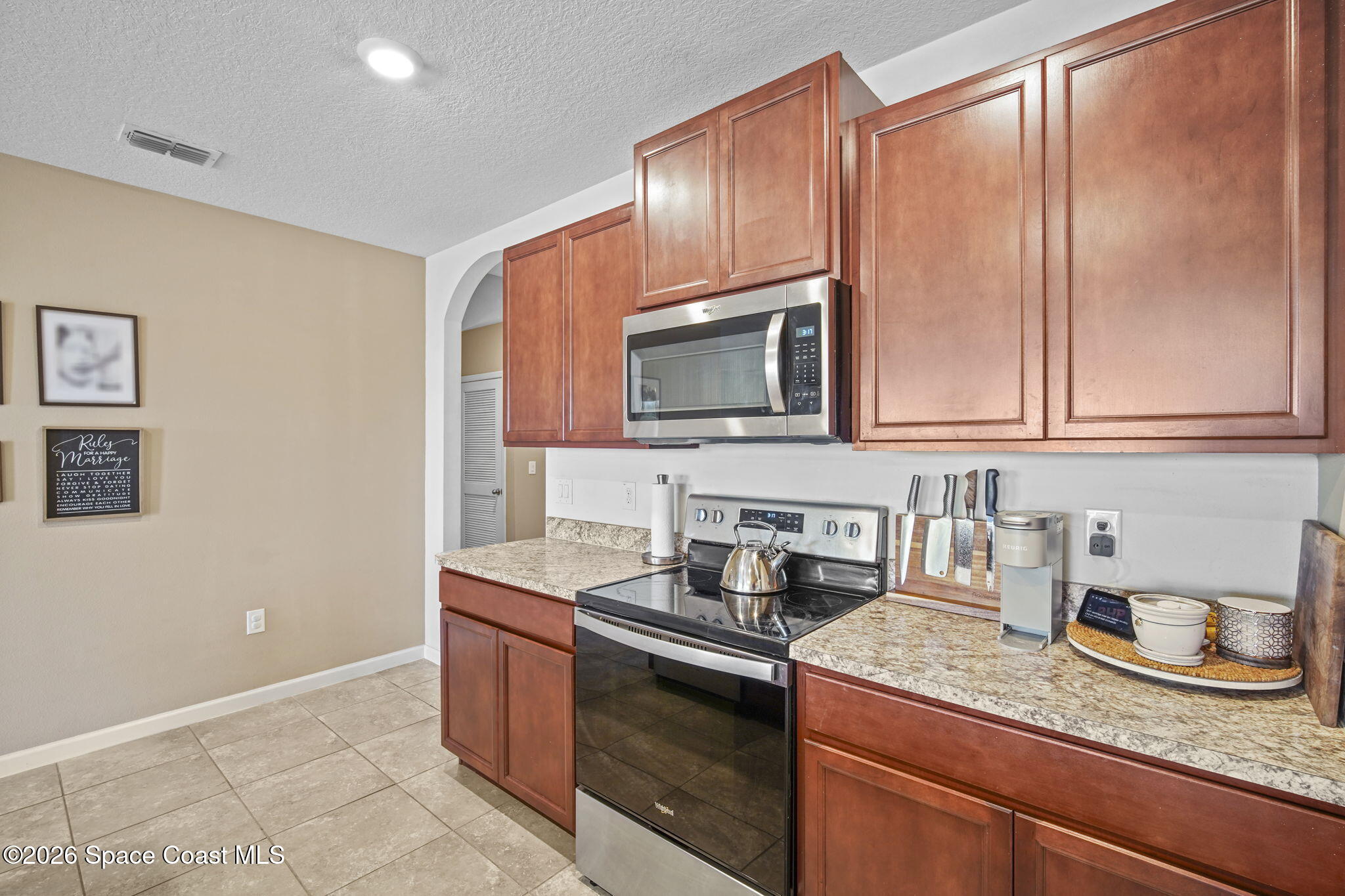 3818 Loggerhead Lane Mims, FL 32754 - Photo 9 of 30 a kitchen with granite countertop cabinets stainless steel appliances and a sink