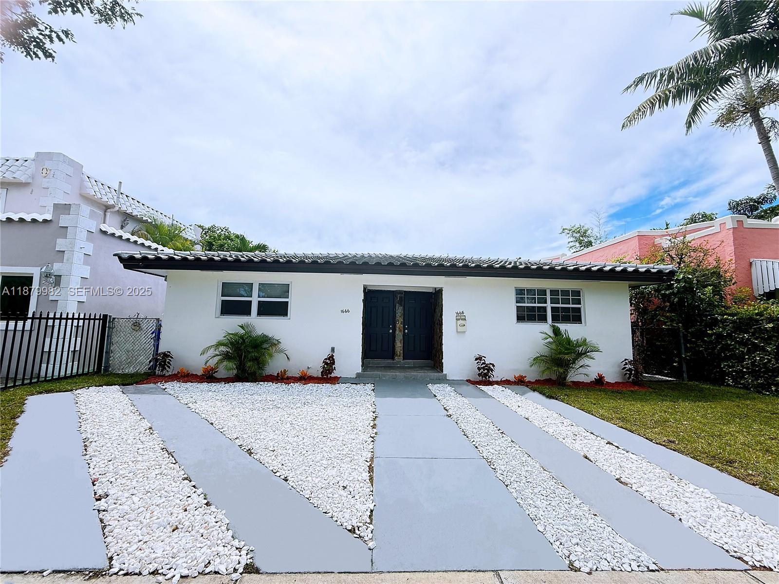 1666-1668 Southwest 9th Street Miami, FL 33135 - Photo 1 of 26 front view of a house with a patio
