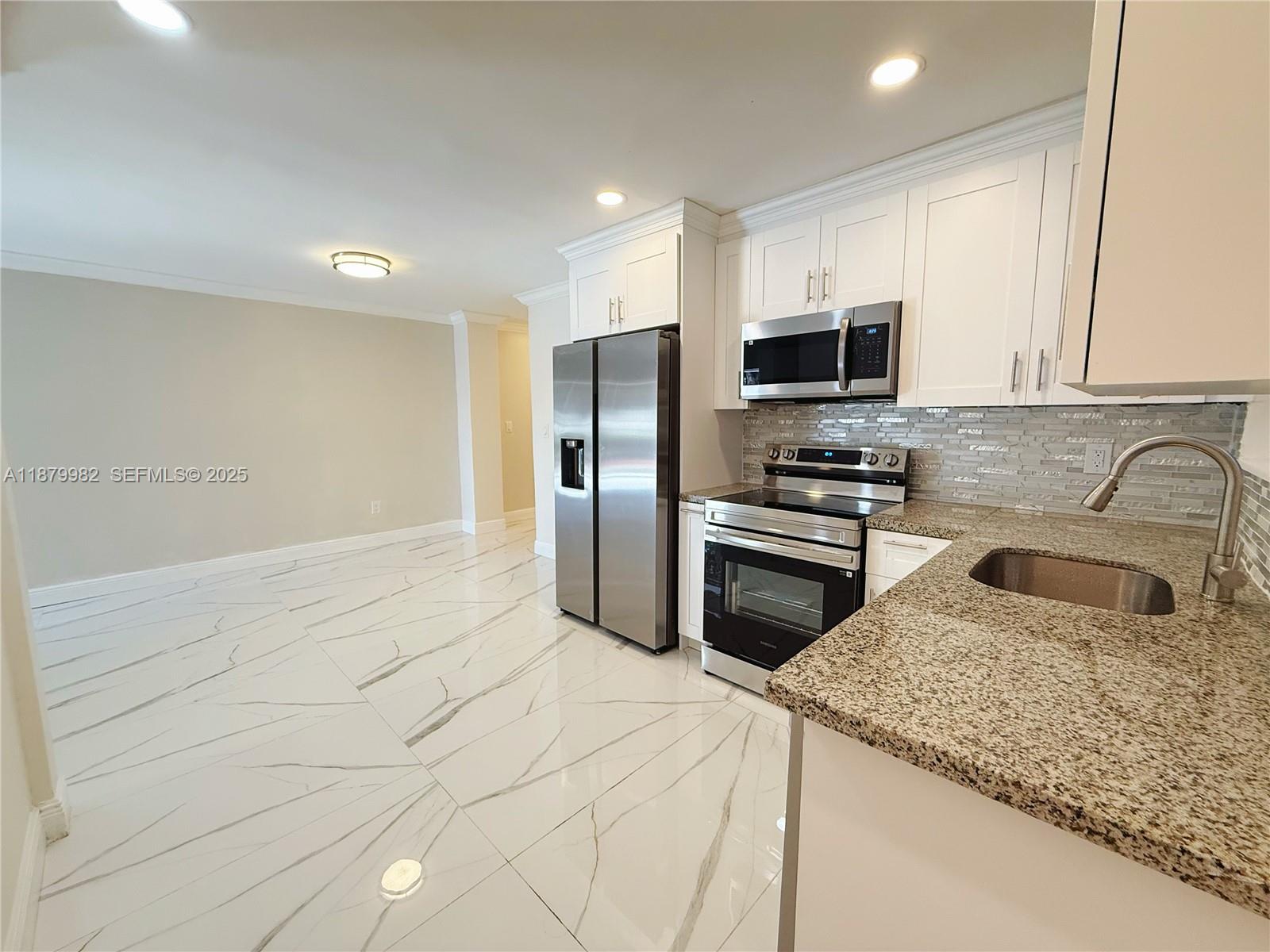 1666-1668 Southwest 9th Street Miami, FL 33135 - Photo 17 of 26 a kitchen with granite countertop a refrigerator and a sink