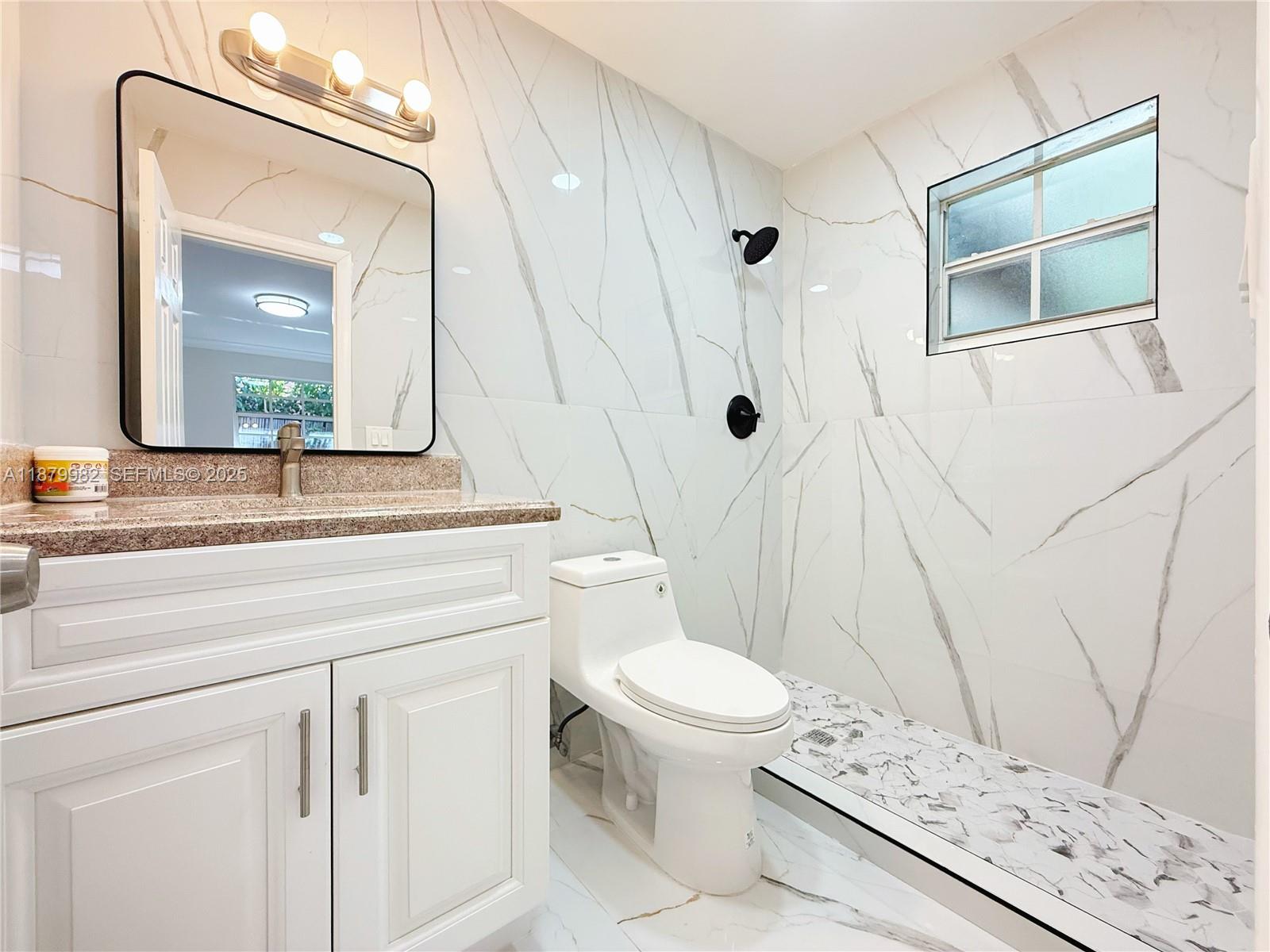 1666-1668 Southwest 9th Street Miami, FL 33135 - Photo 19 of 26 a bathroom with a sink a toilet and a mirror