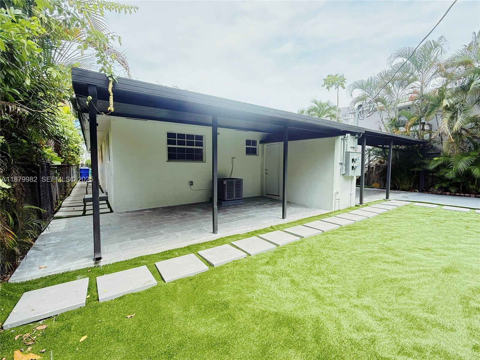 1666-1668 Southwest 9th Street Miami, FL 33135 - Photo 22 of 26 a view of a house with a backyard