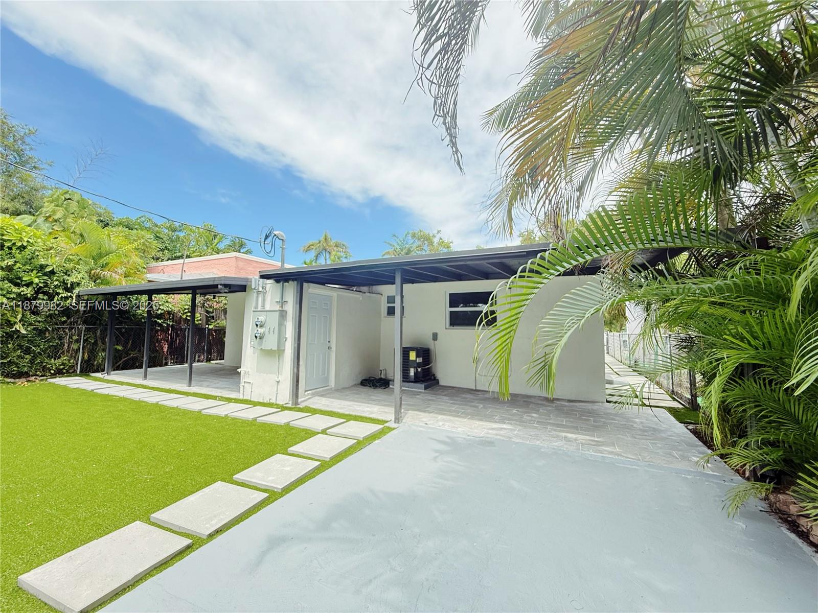 1666-1668 Southwest 9th Street Miami, FL 33135 - Photo 26 of 26 a view of a house with a backyard and a patio