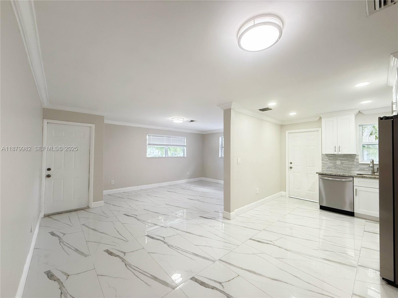 1666-1668 Southwest 9th Street Miami, FL 33135 - Photo 3 of 26 a view of a kitchen with a sink and dishwasher a refrigerator with white cabinets