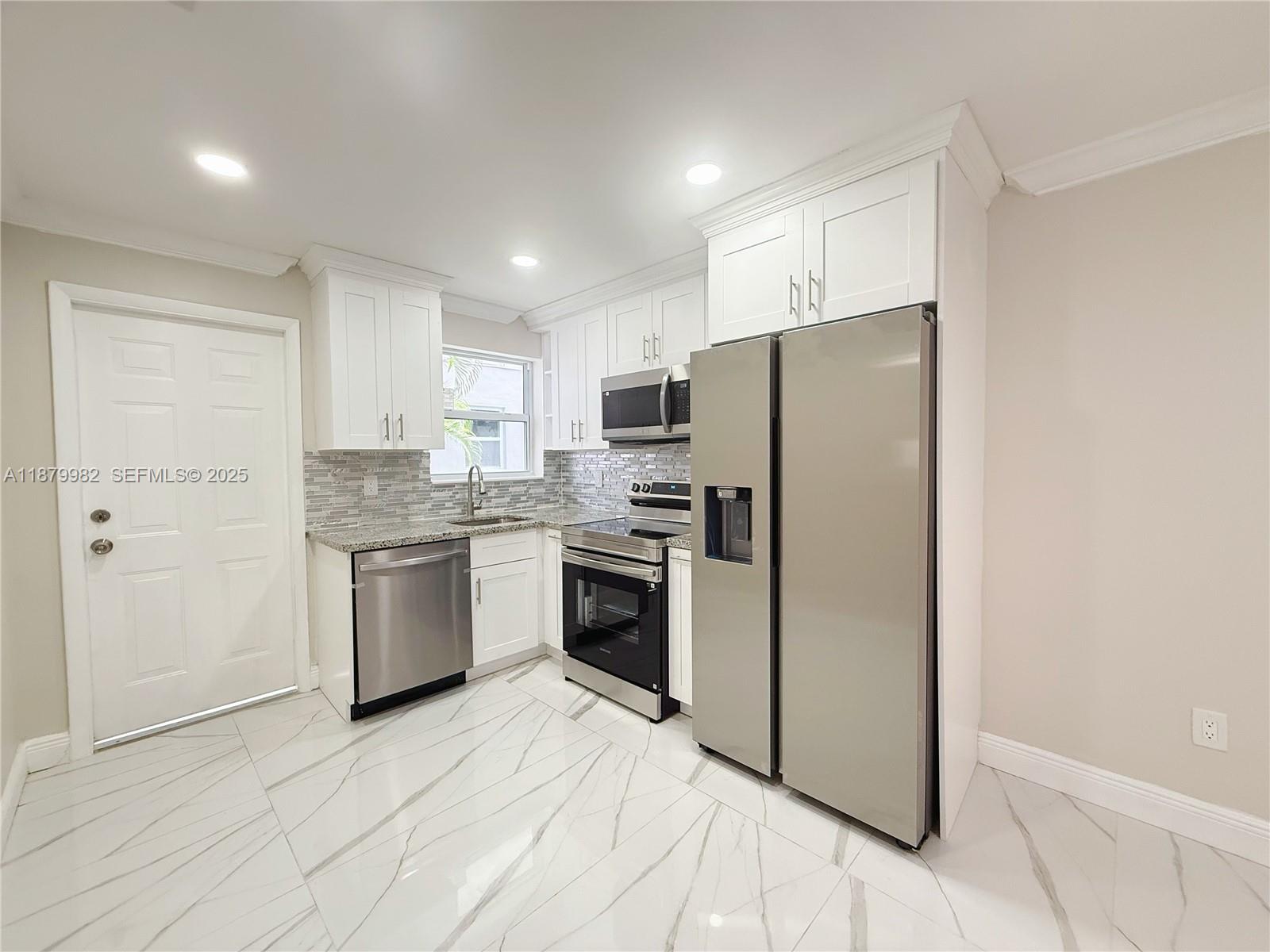 1666-1668 Southwest 9th Street Miami, FL 33135 - Photo 6 of 26 a kitchen with a refrigerator sink and cabinets