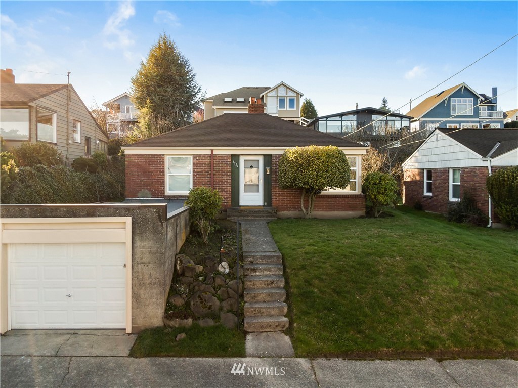3721 37th Avenue Southwest Seattle, WA 98126 - Photo 1 of 19 a front view of a house with a yard
