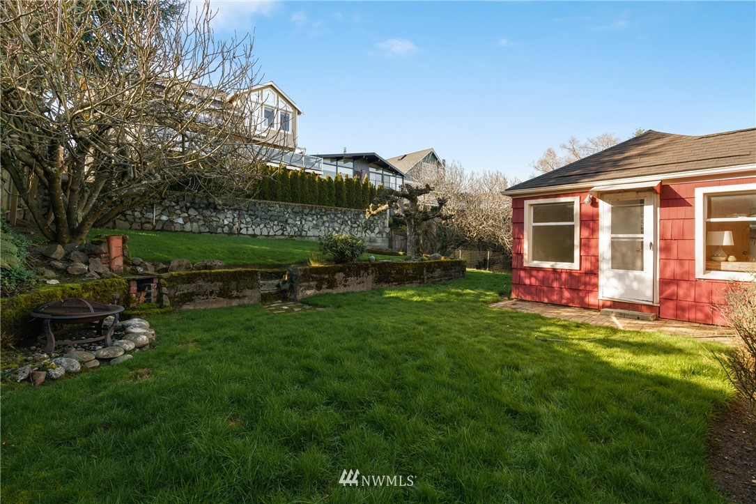 3721 37th Avenue Southwest Seattle, WA 98126 - Photo 16 of 19 a view of a house with a yard