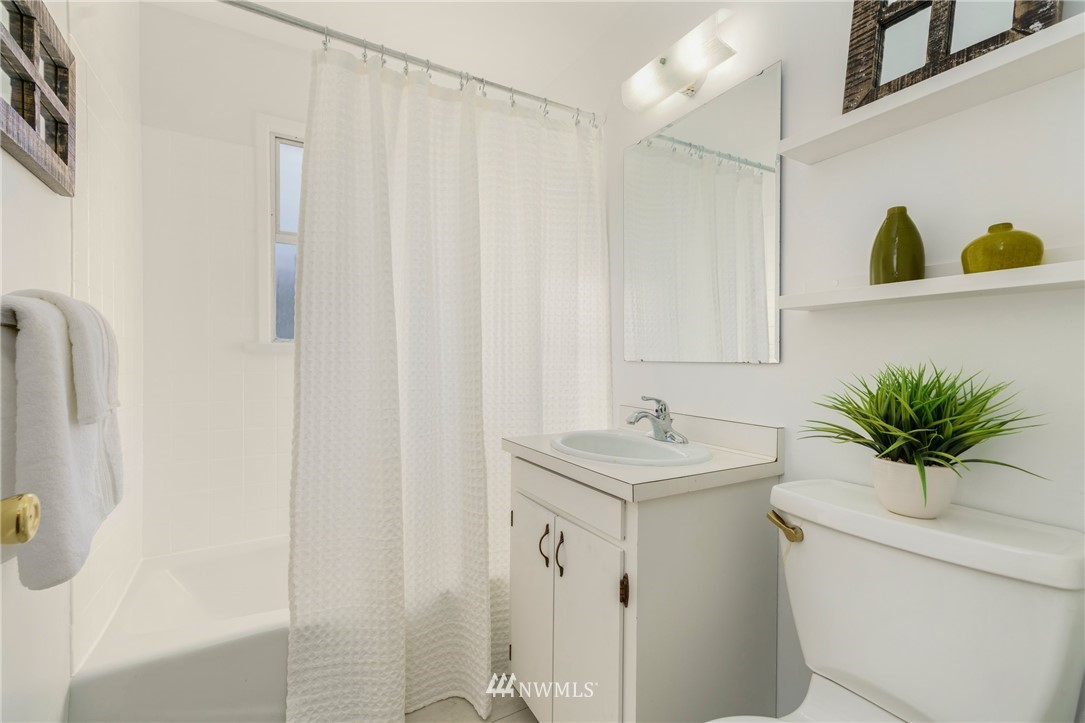 3721 37th Avenue Southwest Seattle, WA 98126 - Photo 7 of 19 a bathroom with a sink a toilet and a mirror